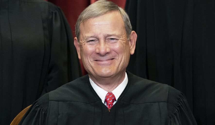 Chief Justice John Roberts sits during a group photo at the Supreme Court in Washington, April 23, 2021. Roberts is set to make his first public appearance since the U.S. Supreme Court overturned Roe v. Wade, speaking Friday night, Sept. 9, 2022, at a judicial conference in Colorado.(Erin Schaff/The New York Times via AP, Pool, File)