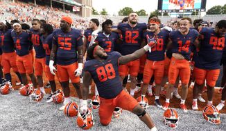 Illinois defensive lineman Keith Randolph Jr., leads his teammates in singing the school&#39;s alma mater after an NCAA college football game against Virginia, Saturday, Sept. 10, 2022, in Champaign, Ill. Illinois won 24-3. (AP Photo/Charles Rex Arbogast)