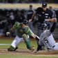 Oakland Athletics catcher Sean Murphy, left, tries to tag Chicago White Sox&#39;s Adam Engel (15), who scored the tying run during the ninth inning of a baseball game in Oakland, Calif., Friday, Sept. 9, 2022. (AP Photo/Godofredo A. Vásquez)