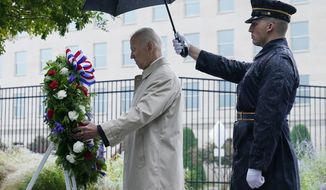 President Joe Biden participates in a wreath laying ceremony while visiting the Pentagon in Washington, Sunday, Sept. 11, 2022, to honor and remember the victims of the September 11th terror attack. (AP Photo/Susan Walsh)