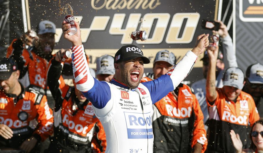 Bubba Wallace celebrates in Victory Lane after winning a NASCAR Cup Series auto race at Kansas Speedway in Kansas City, Kan., Sunday, Sept. 11, 2022. (AP Photo/Colin E. Braley)