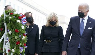 President Joe Biden, first lady Jill Biden, Vice President Kamala Harris and her husband Douglas Emhoff, participate in a wreath ceremony on the 20th anniversary of the terrorist attacks at the Pentagon in Washington, Saturday, Sept. 11, 2021, standing at the National 9/11 Pentagon Memorial site, which commemorates the lives lost at the Pentagon and onboard American Airlines Flight 77. With the President, not shown, are Secretary of Defense Lloyd Austin and Joint Chiefs Chairman Gen. Mark Milley and his wife Hollyanne Milley. (AP Photo/Alex Brandon, File)