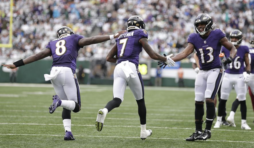 Baltimore Ravens wide receiver Rashod Bateman (7) celebrates with teammates Devin Duvernay (13) and quarterback Lamar Jackson (8) after scoring a touchdown during the second half of an NFL football game against the New York Jets, Sunday, Sept. 11, 2022, in East Rutherford, N.J. (AP Photo/Adam Hunger)