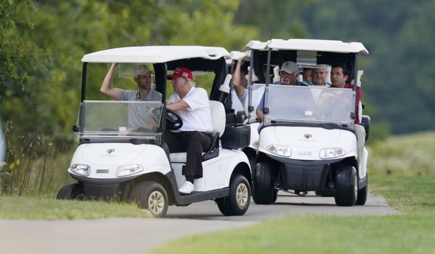 Former President Donald Trump, left cart, rides around his golf course at Trump National Golf Club in Sterling, Va., Monday, Sept. 12, 2022. (AP Photo/Alex Brandon)