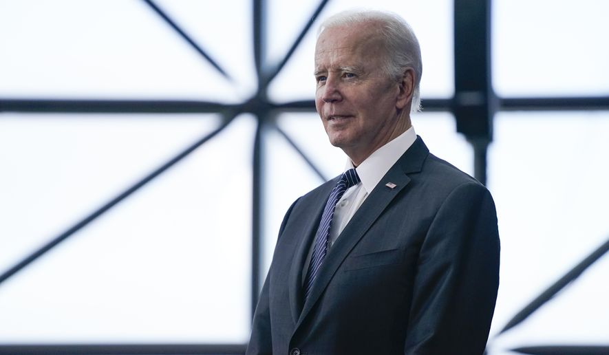 President Joe Biden listens as Ambassador Caroline Kennedy speaks before Biden about the cancer moonshot initiative at the John F. Kennedy Library and Museum, Monday, Sept. 12, 2022, in Boston. (AP Photo/Evan Vucci)