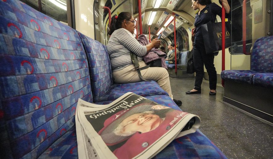 A newspaper with a picture of Queen Elizabeth II lies on a seat in a subway on Monday early morning, Sept. 12, 2022. On morning television, the moment was singularly somber — the departure of the hearse bearing the flag-draped coffin of Queen Elizabeth II. But at the very same hour, as fans in shorts and Ray-Bans streamed into London&#39;s Oval stadium for a long-anticipated cricket match, you wouldn&#39;t have guessed the country was preparing for the most royal of funerals. (AP Photo/Martin Meissner)