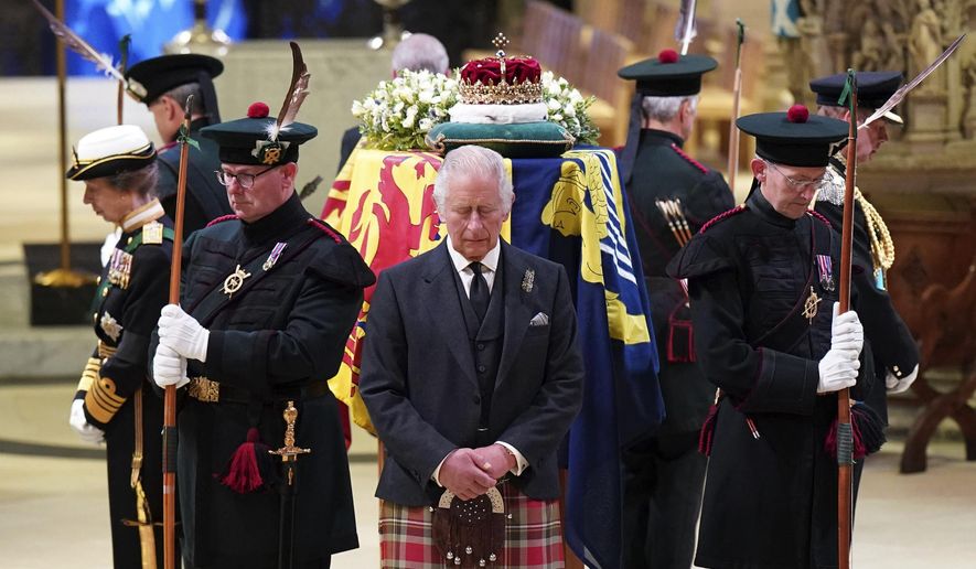 Britain&#x27;s King Charles III, center, and other members of the royal family hold a vigil at the coffin of Queen Elizabeth II at St Giles&#x27; Cathedral, Edinburgh, Scotland, Monday Sept. 12, 2022. (Jane Barlow/Pool via AP)