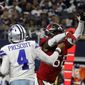 Dallas Cowboys quarterback Dak Prescott (4) is hit by Tampa Bay Buccaneers linebacker Shaquil Barrett (58) while throwing a pass in the second half of a NFL football game in Arlington, Texas, Sunday, Sept. 11, 2022. (AP Photo/Michael Ainsworth) **FILE**