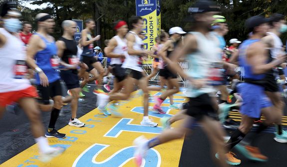 Runners cross the starting line of the 125th Boston Marathon, Monday, Oct. 11, 2021, in Hopkinton, Mass. Nonbinary athletes will be able to run in next year&#39;s Boston Marathon without having to qualify for the men&#39;s or women&#39;s divisions, race organizers announced Monday, Sept. 12, 2022. (AP Photo/Mary Schwalm, File)