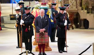 Britain&#39;s King Charles III, center, and other members of the royal family hold a vigil at the coffin of Queen Elizabeth II at St Giles&#39; Cathedral, Edinburgh, Scotland,  Monday Sept. 12, 2022, as members of the public walk past. (Jane Barlow/Pool via AP)