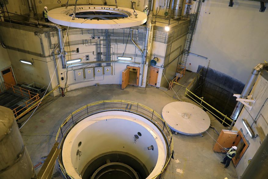 In this photo released by the Atomic Energy Organization of Iran, technicians work on the Arak heavy water reactor's secondary circuit, near Arak, 150 miles southwest of the capital Tehran, Iran, Dec. 23, 2019. (Atomic Energy Organization of Iran via AP)