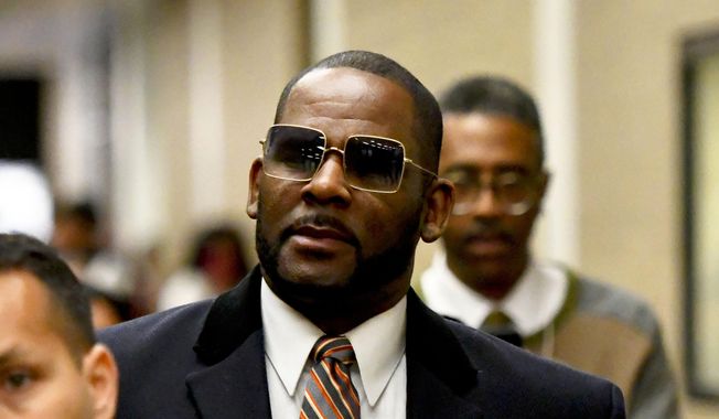 Musician R. Kelly, center, leaves the Daley Center after a hearing in his child support case on May 8, 2019, in Chicago. Closing arguments are scheduled Monday, Sept. 12, 2022 for R. Kelly and two co-defendants in the R&amp;amp;B singer’s trial on federal charges of trial-fixing, child pornography and enticing minors for sex, with jury deliberations to follow. (AP Photo/Matt Marton, File)