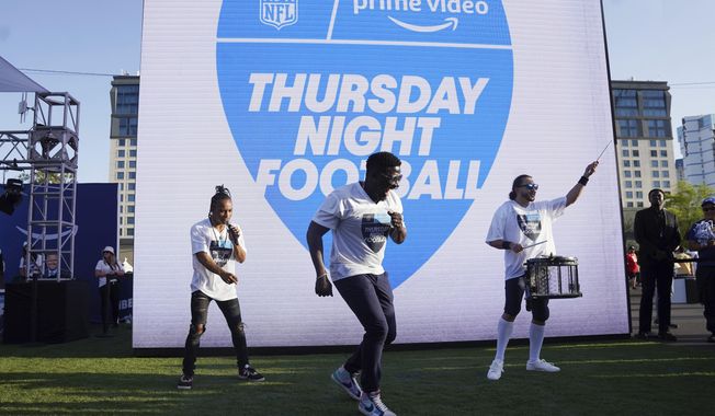Robert &amp;quot;Bojo&amp;quot; Ackah, center, and Fik-Shun, left, perform during the announcement of the first Thursday Night Football on Prime Video matchup featuring the San Diego Chargers at Kansas City Chiefs at the 2022 NFL Draft on Thursday, April 28, 2022 in Las Vegas. The Thursday night, Sept. 15 game between the Los Angeles Chargers and Kansas City Chiefs kicks off Amazon Prime Video&#x27;s 11-year agreement with the NFL to carry “Thursday Night Football&amp;quot;. (AP Photo/Vera Nieuwenhuis, File)