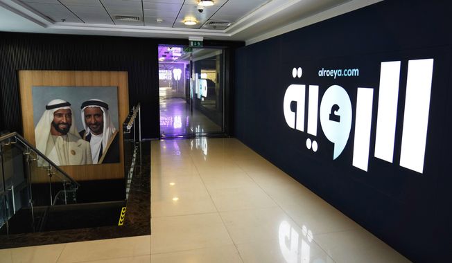 A painting of Sheikh Zayed bin Sultan Al Nahyan, the late leader of the United Arab Emirates and ruler of Abu Dhabi, left, and Sheikh Rashid bin Saeed Al Maktoum, the late ruler of Dubai, hangs outside the offices of the offices of the Al Roeya newspaper in Dubai, UAE, Sept. 3, 2022. A state-linked newspaper published a story this summer about a hot-button issue in the country: How Emiratis are coping with high fuel prices. It ended up seeing over 40 people fired and the paper was declared dissolved. The purge at Al Roeya newspaper reflects the intense challenges facing local journalists in the UAE. (AP Photo/Jon Gambrell)