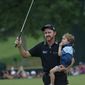 Jimmy Walker celebrates with his son Beckett after winning the PGA Championship golf tournament at Baltusrol Golf Club in Springfield, N.J., on July 31, 2016. Walker earned a full PGA Tour card for the season that starts Thursday, Sept. 15, 2022, because of all the LIV Golf defections. Walker had walked away from golf in April. (AP Photo/Mike Groll, File) **FILE**
