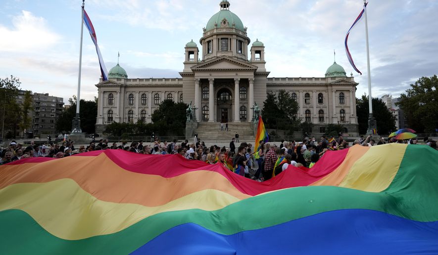 In this filephoto, participants carry large rainbow flag in front of the parliament building as they take part in the annual LGBT pride march in Belgrade, Serbia, Saturday, Sept. 18, 2021. Serbia&#39;s police on Tuesday banned an international Pride march that is to be held later this week, citing a risk of clashes between gay rights activists and far-right opponents of a pan-European LGBTQ events planned for this week in Belgrade. (AP Photo/Darko Vojinovic, File)  **FILE**