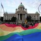 In this filephoto, participants carry large rainbow flag in front of the parliament building as they take part in the annual LGBT pride march in Belgrade, Serbia, Saturday, Sept. 18, 2021. Serbia&#39;s police on Tuesday banned an international Pride march that is to be held later this week, citing a risk of clashes between gay rights activists and far-right opponents of a pan-European LGBTQ events planned for this week in Belgrade. (AP Photo/Darko Vojinovic, File)  **FILE**