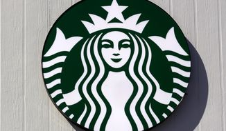 The logo on a sign outside the Starbucks coffee shop, March 14, 2022, in Londonderry, N.H. Starbucks plans to spend $450 million next year to make its North American stores more efficient and less complex. The company also said it plans to open 2,000 net new stores in the U.S. by 2025. The emphasis will be on meeting the growing demand for drive-thru and delivery. Starbucks recently saw the best week in its 51-year history when it introduced its latest fall drinks. But it says stores need better equipment to make drinks more quickly. Among the things driving the revamp is an ongoing unionization effort, which Starbucks opposes. More than 230 U.S. stores have voted to unionize since late last year. (AP Photo/Charles Krupa, file)