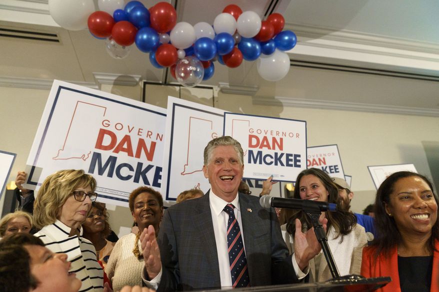 Rhode Island Gov. Dan McKee, joined by Lt. Gov. Sabina Matos, right, gives an acceptance speech in front of supporters at a primary election night watch party in Providence, R.I., Tuesday, Sept. 13, 2022. (AP Photo/David Goldman)