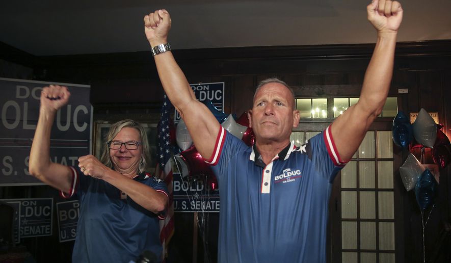 New Hampshire Republican U.S. Senate candidate Don Bolduc and his wife Sharon gesture during a primary night campaign gathering, Tuesday Sept. 13, 2022, in Hampton, N.H. (AP Photo/Reba Saldanha)