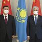 In this handout photo released by Kazakhstan President press-service, Kazakhstan President Kassym-Jomart Tokayev, left, and Chinese President Xi Jinping pose for photo during their meeting in Nur-Sultan, Kazakhstan, Wednesday, Sept. 14, 2022. (Kazakhstan President press-service via AP)