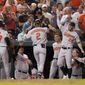 Baltimore Orioles&#39; Gunnar Henderson returns to the dugout and celebrates with Terrin Vavra, left, Brandon Hyde, Robinson Chirinos, Ryan McKenna, Adley Rutschman and Kyle Stowers after his three-RBI triple during the seventh inning of a baseball game at Nationals Park, Tuesday, Sept. 14, 2022, in Washington. (AP Photo/Jess Rapfogel)