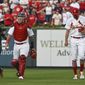 St. Louis Cardinals&#x27; Yadier Molina, left, and Adam Wainwright walk in from the bullpen after warming up for the team&#x27;s baseball game against the Milwaukee Brewers on Wednesday Sept. 14, 2022, in St. Louis. (AP Photo/Joe Puetz)