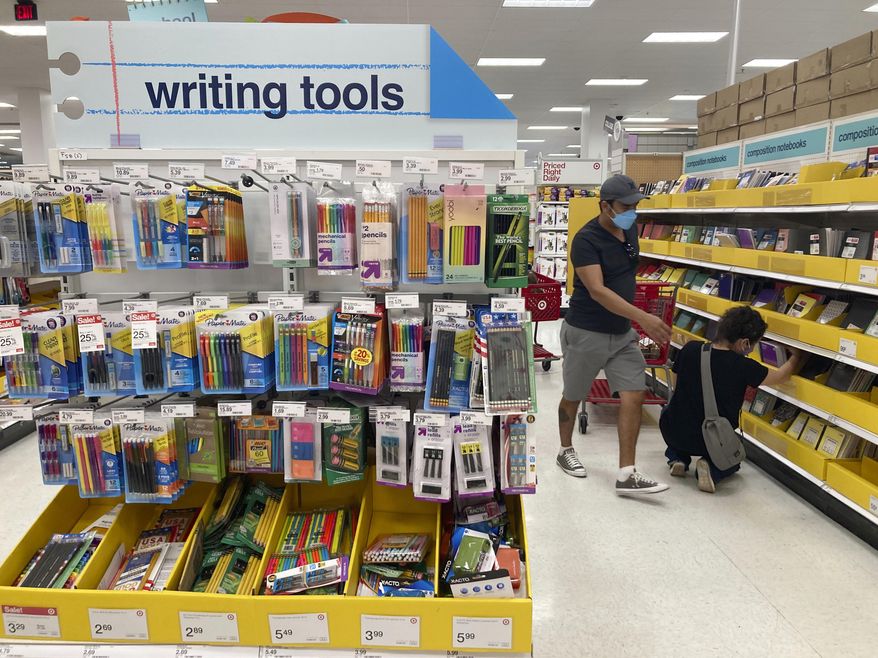 Shoppers look for school supplies at a store, Wednesday, July 27, 2022, in South Miami, Fla. Economists are saying strong consumer demand, spurred by rising wages, is fueling inflation. (AP Photo/Marta Lavandier, File)