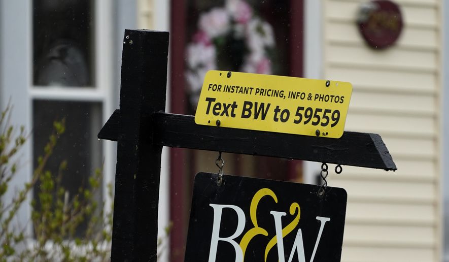 A sign is displayed outside a home in Wheeling, Ill., on May 5, 2022. Average long-term U.S. mortgage rates climbed over 6% this week for the first time since the housing crash of 2008, threatening to sideline even more homebuyers from a rapidly cooling housing market. Mortgage buyer Freddie Mac reported Thursday, Sept. 15, 2022, that the 30-year rate rose to 6.02% from 5.89% last week. (AP Photo/Nam Y. Huh)