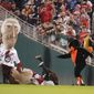 The Oriole Bird points at Teddy Roosevelt after pushing him to the ground in front of George Washington, left, and Thomas Jefferson while participating in the Presidents Race during the sixth inning of a baseball game at Nationals Park, Tuesday, Sept. 14, 2022, in Washington. (AP Photo/Jess Rapfogel)