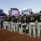 Members of the Pittsburgh Pirates, wearing No. 21 for Roberto Clemente, stand for the national anthem before a baseball game against the New York Mets on Thursday, Sept. 15, 2022, in New York. (AP Photo/Adam Hunger)
