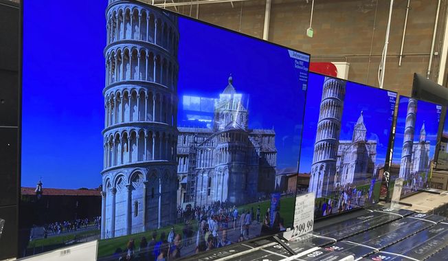 A 65-inch television is shown at a warehouse, Thursday, June 17, 2021, in Lone Tree, Colo. Buy now, pay later loans allow users to pay for items such as new sneakers, electronics or luxury goods in installments. (AP Photo/David Zalubowski, File)