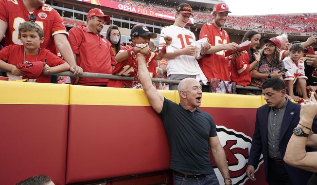 Amazon founder Jeff Bezos greets fans before the start of an NFL football game between the Kansas City Chiefs and the Los Angeles Chargers Thursday, Sept. 15, 2022, in Kansas City, Mo. (AP Photo/Ed Zurga)