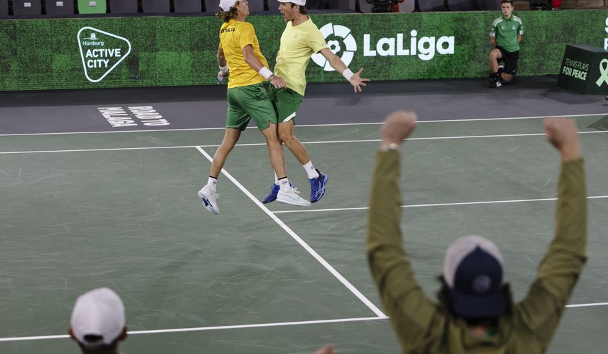Australia&#39;s Matthew Ebden, right, and Max Purcell celebrate during the Davis Cup group C tennis match  against France&#39;s Nicolas Mahut and Arthur Rinderknech, in Hamburg, Germany Thursday, Sept. 15, 2022. (Frank Molter/dpa via AP)