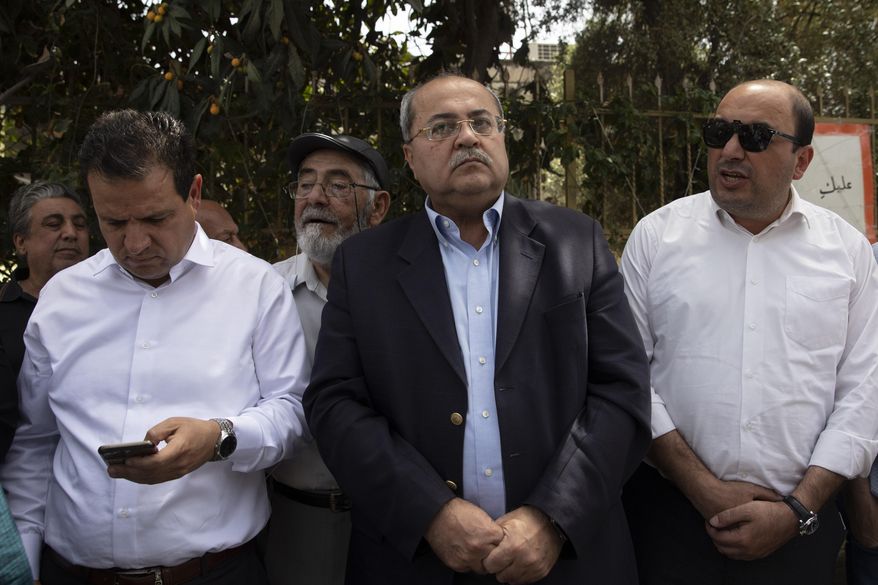 FILE - Israeli Arab politicians, from foreground left, Ayman Odeh, Ahmad Tibi and Sami Abu Shehadeh, stand during a visit to the Sheikh Jarrah neighborhood of East Jerusalem, Monday, May 10, 2021. Israeli media reported late Thursday, Sept. 15, 2022, that the nationalist Balad party will run separately from the other two parties in the Joint List. If it does not meet the minimum threshold, Balad would not enter the next parliament and its votes would essentially be wasted. (AP Photo/Sebastian Scheiner, File)