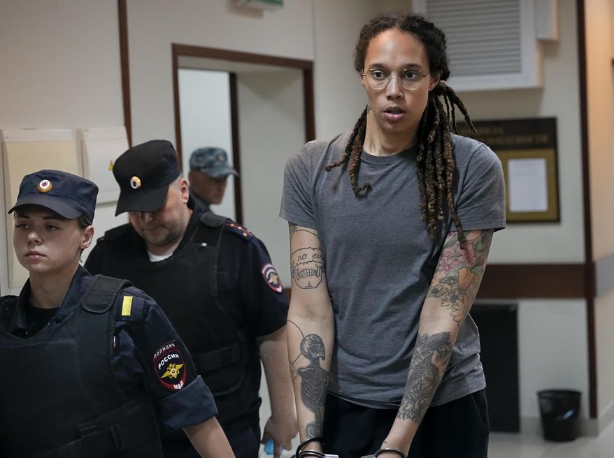 WNBA star and two-time Olympic gold medalist Brittney Griner is escorted from a court room ater a hearing, in Khimki just outside Moscow, Russia, Aug. 4, 2022.  (AP Photo/Alexander Zemlianichenko, File) **FILE**