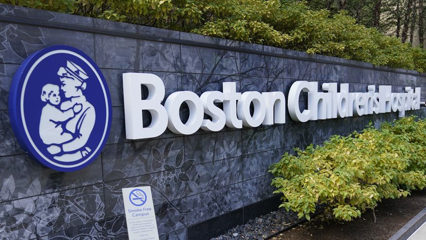 A sign hangs on a wall outside the Boston Children's Hospital in Boston on Thursday, Aug. 18, 2022. (AP Photo/Charles Krupa)