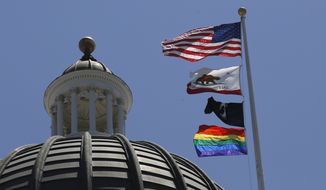 The rainbow Pride flag flutters from the flag pole at the state Capitol in Sacramento, Calif., Monday, June 17, 2019. California&#39;s governor has signed a law he says will help military service members who were discharged under &quot;don&#39;t ask, don&#39;t tell&quot; policies to reestablish eligibility for Veterans Affairs benefits. Gov. Gavin Newsom said Saturday, Sept. 17, 2022, many veterans who were discharged because of sexual or gender identities don&#39;t know how to access benefits they might be eligible for. The law requires the state to create a grant program to help LGBTQ veterans through the process. (AP Photo/Rich Pedroncelli, File)