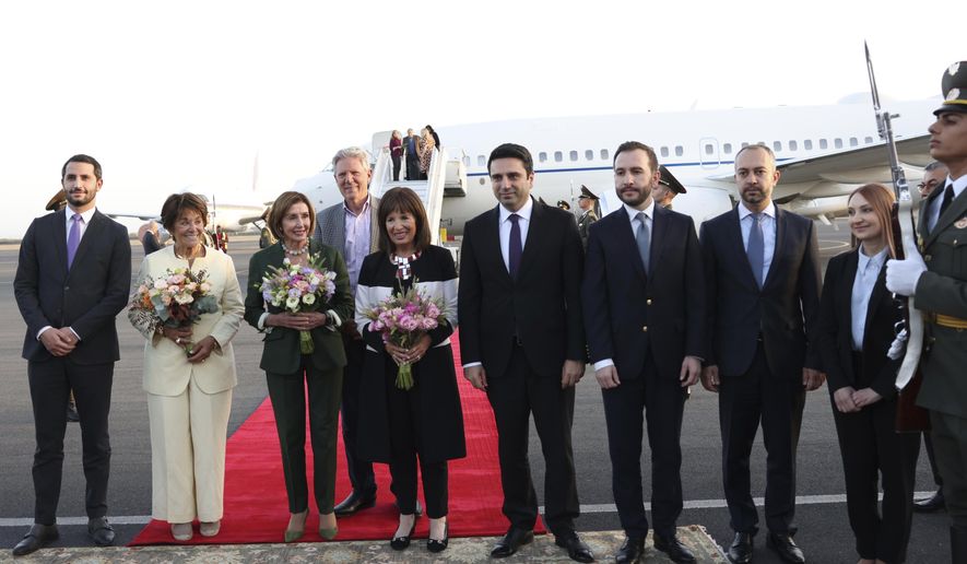 U.S. House of Representatives Nancy Pelosi, third left, and Head of Armenian National Assembly Alen Simonyan, fourth right, pose for a photo with other officials upon arrival at the International Airport outside of Yerevan, Armenia, Saturday, Sept. 17, 2022. A US Congressional delegation headed by Speaker of the House Nancy Pelosi arrived Saturday in Armenian, where a cease-fire has held for three days after an outburst of fighting with neighboring Azerbaijan that killed more than 200 troops from both sides. (Photolure photo via AP)