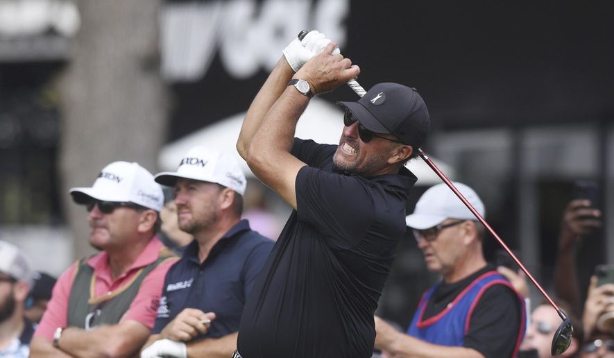 Phil Mickelson watches the flight of his tee shot on the first hole during the second round of the LIV Golf Invitational-Chicago tournament Saturday, Sept. 17, 2022, in Sugar Grove, Ill. (Joe Lewnard/Daily Herald via AP) **FILE**