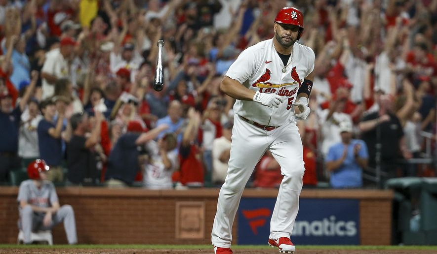 St. Louis Cardinals&#x27; Albert Pujols tosses his bat after hitting a two-run home run during the sixth inning of the team&#x27;s baseball game against the Cincinnati Reds on Friday, Sept. 16, 2022, in St. Louis. (AP Photo/Scott Kane)