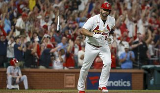 St. Louis Cardinals&#39; Albert Pujols tosses his bat after hitting a two-run home run during the sixth inning of the team&#39;s baseball game against the Cincinnati Reds on Friday, Sept. 16, 2022, in St. Louis. (AP Photo/Scott Kane)