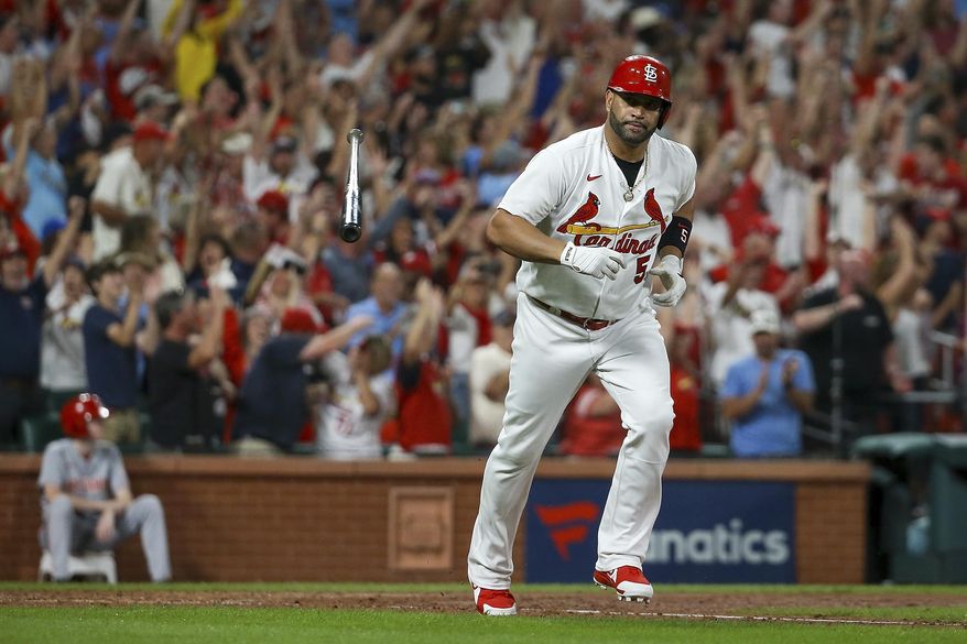 St. Louis Cardinals&#x27; Albert Pujols tosses his bat after hitting a two-run home run during the sixth inning of the team&#x27;s baseball game against the Cincinnati Reds on Friday, Sept. 16, 2022, in St. Louis. (AP Photo/Scott Kane)