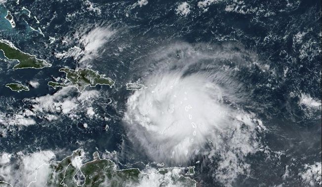 This satellite image provided by NOAA shows Tropical Storm Fiona in the Caribbean on Saturday, Sept. 17, 2022.  Fiona threatened to dump up to 16 inches (41 centimeters) of rain in parts of Puerto Rico on Saturday as forecasters placed the U.S. territory under a hurricane watch and people braced for potential landslides, severe flooding and power outages. (NOAA via AP)