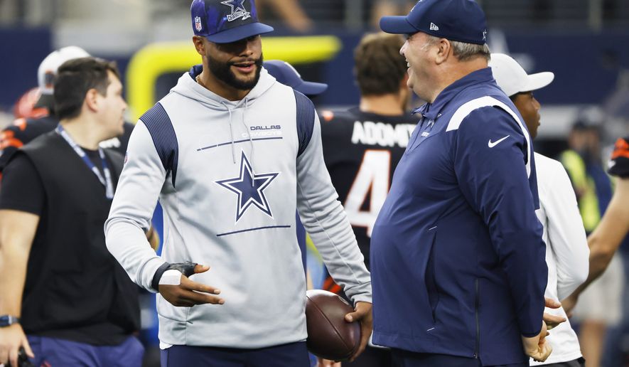 An injured Dallas Cowboys quarterback Dak Prescott, left, talks with head coach Mike McCarthy, right, prior to an NFL football game Sunday, Sept. 18, 2022, in Arlington, Tx. (AP Photo/Ron Jenkins)