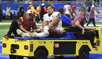 Washington Commanders center Chase Roullier (73) is taken out of the field for injury during the second half of an NFL football game against the Detroit Lions Sunday, Sept. 18, 2022, in Detroit. (AP Photo/Lon Horwedel)