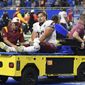 Washington Commanders center Chase Roullier (73) is taken out of the field for injury during the second half of an NFL football game against the Detroit Lions Sunday, Sept. 18, 2022, in Detroit. (AP Photo/Lon Horwedel)