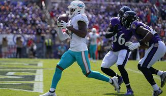 Miami Dolphins wide receiver Jaylen Waddle (17) scores a touchdown during the first half of an NFL football game against the Baltimore Ravens, Sunday, Sept. 18, 2022, in Baltimore. (AP Photo/Julio Cortez) **FILE**