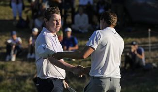 Matt Fitzpatrick of England, right, congratulates with Bob MacIntyre of Scotland, winner of the Italian Open golf tournament in Guidonia Montecelio, near Rome, Italy, Sunday, Sept. 18, 2022. The Italian Open took place on the Marco Simone course that will host the 2023 Ryder Cup. (AP Photo/Alessandra Tarantino)