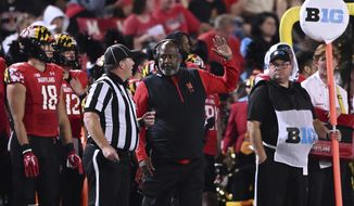Maryland head coach Michael Locksley, left, talks with a referee during an NCAA college football game, Saturday, Sept. 17, 2022, College Park, MD. (AP Photo/Gail Burton)